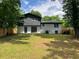 Backyard of the house featuring a manicured lawn, modern paint job, and a privacy fence at 3640 Narron Dr, Atlanta, GA 30331