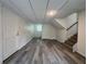 Finished basement featuring gray flooring, access to stairs, and a brightly painted white door at 3640 Narron Dr, Atlanta, GA 30331