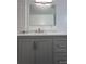 Modern bathroom vanity with a granite countertop, chrome hardware, and large mirror at 3640 Narron Dr, Atlanta, GA 30331