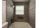 Close up of the renovated tile shower with upgraded showerhead in a modern bathroom at 3640 Narron Dr, Atlanta, GA 30331