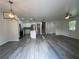Open concept kitchen features stainless steel appliances, gray floors, and access to the stairs at 3640 Narron Dr, Atlanta, GA 30331