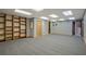Carpeted basement with built-in shelving and a doorway leading to another room at 4950 Creel Rd, Chattahoochee Hills, GA 30213