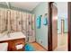 Well-lit bathroom with wood vanity, single sink, and coordinated blue bath accessories at 4950 Creel Rd, Chattahoochee Hills, GA 30213