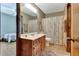 Cozy bathroom featuring wood vanity and mirror, shower curtain, and wood trim at 4950 Creel Rd, Chattahoochee Hills, GA 30213