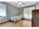 Cozy bedroom with a twin bed, ceiling fan, and natural light from the windows at 4950 Creel Rd, Chattahoochee Hills, GA 30213