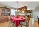 Cozy dining room features a red table setting, wood floors, and traditional china cabinet at 4950 Creel Rd, Chattahoochee Hills, GA 30213