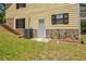 Exterior of a yellow home showing a stone foundation and a grassy yard at 4950 Creel Rd, Chattahoochee Hills, GA 30213