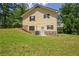 Exterior of a two-story yellow home with a large grassy yard and mature trees at 4950 Creel Rd, Chattahoochee Hills, GA 30213