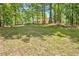 Beautiful home nestled in a wooded lot offering lots of shade and privacy from the surrounding trees at 4950 Creel Rd, Chattahoochee Hills, GA 30213