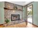 Stone fireplace with wood mantel and deck access at 4950 Creel Rd, Chattahoochee Hills, GA 30213