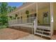 Charming home featuring a covered front porch decorated with hanging plants and lovely decor at 4950 Creel Rd, Chattahoochee Hills, GA 30213