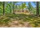 Inviting front porch with a rocking chair offering views of the surrounding yard and trees at 4950 Creel Rd, Chattahoochee Hills, GA 30213