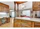 Kitchen features wood cabinets, an island, and an adjoining dining area at 4950 Creel Rd, Chattahoochee Hills, GA 30213