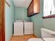 Convenient laundry space featuring a stacked washer and dryer and storage cabinet at 4950 Creel Rd, Chattahoochee Hills, GA 30213