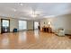 Open living room with wood floors, neutral walls, and plentiful natural light at 4950 Creel Rd, Chattahoochee Hills, GA 30213