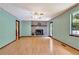 Open living room with a stone fireplace and access to the deck at 4950 Creel Rd, Chattahoochee Hills, GA 30213