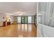 Bright living room with hardwood floors, ceiling fan and access to deck through french doors at 4950 Creel Rd, Chattahoochee Hills, GA 30213