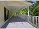 Long covered porch overlooks mature shade trees at 4950 Creel Rd, Chattahoochee Hills, GA 30213