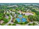 Wide shot of community amenities with tennis courts, pool, pond and a variety of beautiful homes at 5105 Deerlake Dr, Alpharetta, GA 30005