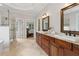 This bathroom features a double vanity, stand alone shower, and a view to the main bedroom at 5105 Deerlake Dr, Alpharetta, GA 30005