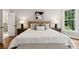 This bedroom features a king size bed, hardwood floors, and windows overlooking a wooded area at 5105 Deerlake Dr, Alpharetta, GA 30005