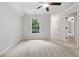 Bright bedroom with plush carpet, ceiling fan, and a window view to the outdoors at 5105 Deerlake Dr, Alpharetta, GA 30005