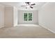 Bright bedroom with plush carpet, ceiling fan, and a window view of the outdoors at 5105 Deerlake Dr, Alpharetta, GA 30005