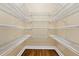 A walk-in closet with custom shelving, designed for optimal storage and organization at 5105 Deerlake Dr, Alpharetta, GA 30005