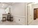 Elegant dining area adjacent to the kitchen, with wainscoting and access to wine cellar at 5105 Deerlake Dr, Alpharetta, GA 30005
