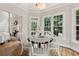 Charming dining area bathed in natural light, featuring a fireplace, creating a warm ambiance for meals at 5105 Deerlake Dr, Alpharetta, GA 30005