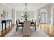 Charming dining room with hardwood floors, crown molding, large windows, and a modern chandelier at 5105 Deerlake Dr, Alpharetta, GA 30005