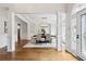 Open-concept dining room featuring hardwood floors, decorative pillars, and a view to the ornate glass front door at 5105 Deerlake Dr, Alpharetta, GA 30005