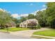 Charming home boasting a beautifully manicured lawn, mature trees, and a welcoming circular driveway at 5105 Deerlake Dr, Alpharetta, GA 30005