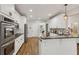 This kitchen features stainless steel appliances and an island, offering both style and functionality at 5105 Deerlake Dr, Alpharetta, GA 30005
