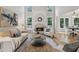 Bright living room with high ceilings, a fireplace, and natural light, providing a comfortable gathering space at 5105 Deerlake Dr, Alpharetta, GA 30005