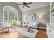 Bright living room with hardwood floors, vaulted ceiling, large windows, and a stylish seating arrangement at 5105 Deerlake Dr, Alpharetta, GA 30005