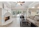 Cozy living room with a stone fireplace, large windows, and access to the outdoor space at 5105 Deerlake Dr, Alpharetta, GA 30005