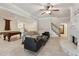 Expansive living room featuring a fireplace, pool table, staircase, and an open layout at 5105 Deerlake Dr, Alpharetta, GA 30005