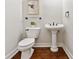 This powder room features hardwood floors, pedestal sink, and picture frame molding at 5105 Deerlake Dr, Alpharetta, GA 30005