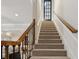 Carpeted staircase with wood railings, connecting the home's levels at 5105 Deerlake Dr, Alpharetta, GA 30005