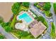 Overhead view of a community pool with a splash pad, surrounded by lush greenery and lounge seating at 5105 Deerlake Dr, Alpharetta, GA 30005