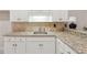 Well-equipped wet bar with granite countertops, custom cabinets, and tiled backsplash at 5105 Deerlake Dr, Alpharetta, GA 30005