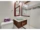 Modern bathroom features glass shower, vessel sink with wood vanity and decorative lighting at 606 Evergreen Dr, Woodstock, GA 30188