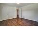 This bedroom features wood floors, neutral walls, and two doors at 606 Evergreen Dr, Woodstock, GA 30188
