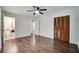 Bedroom with hardwood floors, ceiling fan, closet, and ensuite bathroom access at 606 Evergreen Dr, Woodstock, GA 30188