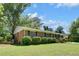 Beautiful home with a lush lawn and manicured landscaping at 606 Evergreen Dr, Woodstock, GA 30188