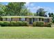 Charming brick home features a well-manicured lawn and lush landscaping at 606 Evergreen Dr, Woodstock, GA 30188