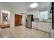 Traditional kitchen with stainless steel refrigerator, white cabinets, and spacious tile flooring at 606 Evergreen Dr, Woodstock, GA 30188