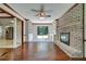 Living room featuring a brick fireplace, built-in shelving, and hardwood floors at 606 Evergreen Dr, Woodstock, GA 30188