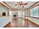 Spacious living room with hardwood floors, brick fireplace, and an open floorplan at 606 Evergreen Dr, Woodstock, GA 30188